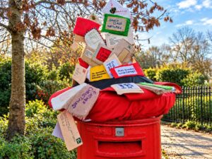 Christmas postbox in St Albans overflowing with handmade letters addressed to Santa Claus