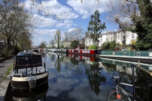 Grand Union Canal leaving Browning’s Pool at Little Venice in west London with moored narrowboats
