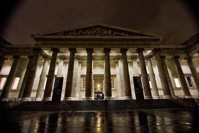 Front of The British Museum at night.