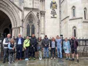 London Walks guide Joanne, criminal defence lawyer, with walking group outside the Royal Courts of Justice, London