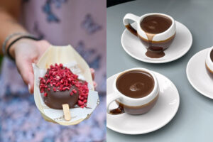 Chocolate-covered ice cream topped with raspberry pieces and cups of rich hot chocolate on a café table in Notting Hill.