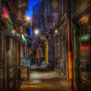 Atmospheric East End alleyway at night in Spitalfields, London — evocative of the streets of the Jack the Ripper murders.