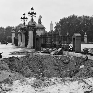 Bomb crater and wartime damage outside the gates of Buckingham Palace during the Blitz, 1940.