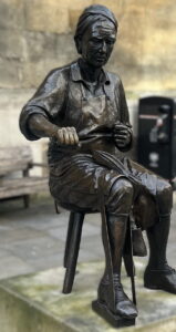 Bronze statue of a cordwainer at work in the City of London