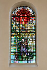 Dick Whittington depicted with his cat in a colourful stained-glass window in the City of London