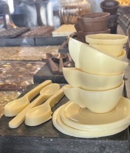 White chocolate cups, saucers and spoons in a London chocolatier.